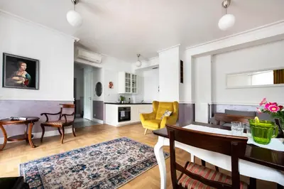 a living room with a dining table and a kitchen at GROBLE 19 in Kraków