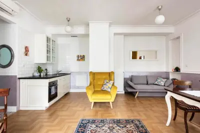 a living room with a yellow chair and a couch at GROBLE 19 in Kraków