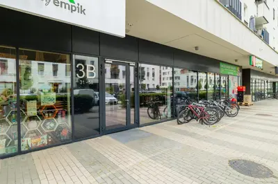 a store front with bikes parked inside of it at Osiedle Avia Family Apartment in Kraków with Balcony by Noclegi Renters in Kraków