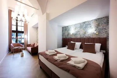 a bedroom with a large bed with two pillows on it at Bracka Main Square Apartments in Kraków