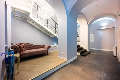 a living room with a couch and a staircase at Bracka Main Square Apartments in Kraków