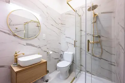 a bathroom with a sink toilet and a mirror at Bracka Main Square Apartments in Kraków