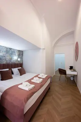 a bedroom with a large bed with towels on it at Bracka Main Square Apartments in Kraków