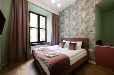 a bedroom with a bed with two towels on it at Bracka Main Square Apartments in Kraków