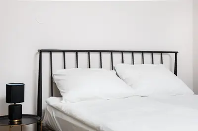 a bed with white sheets and pillows on it at City of the Kings-Poselska 24 in Kraków