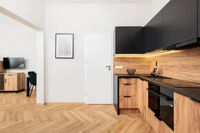 a kitchen with a counter top and wooden floors at City of the Kings-Poselska 24 in Kraków