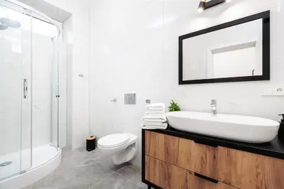 a bathroom with a sink and a toilet and a mirror at City of the Kings-Poselska 24 in Kraków