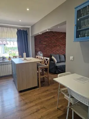a living room with a couch and a table and chairs at Stefczyka 119 in Bachowice