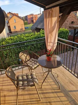 a patio with two chairs and a table on a balcony at Stefczyka 119 in Bachowice