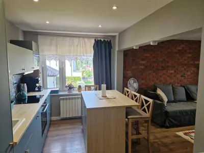 a kitchen and living room with a table and a couch at Stefczyka 119 in Bachowice