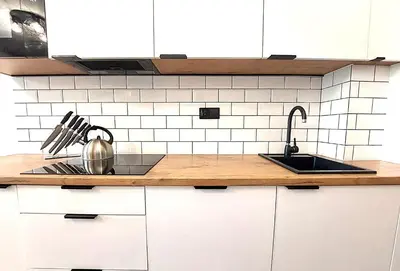 a kitchen with a sink and a counter with a tea kettle at Royal Smart Apartments Cracow in Kraków