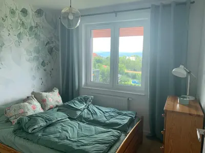a bed in a room with a window at Apartament Smile in Tomice