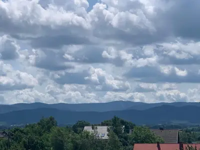 a cloudy sky with mountains in the distance at Apartament Smile in Tomice