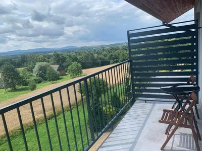 a balcony with a view of the mountains at Apartament Smile in Tomice