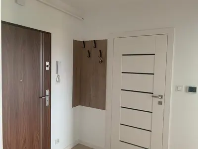 a room with a door and a wooden cabinet at Apartament Smile in Tomice