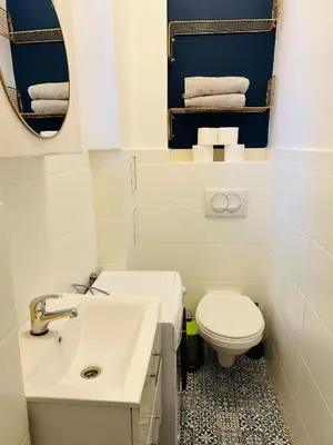 a bathroom with a white sink and a toilet at Długa apartament in Kraków