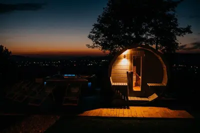 a small cabin with a lit up door at night at Górskie Tarasy in Rabka