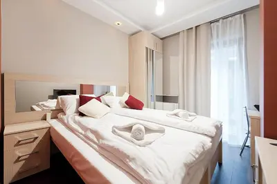 a bedroom with a large bed with towels on it at Novum City Center, Sun & Snow in Kraków