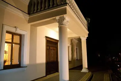 a front porch of a house at night at Pokoje Gościnne w Ratuszu in Ogrodzieniec