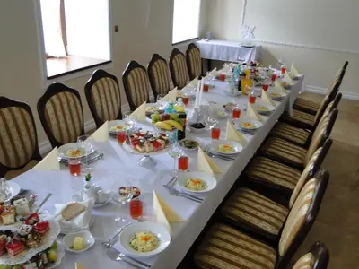 a long table with plates of food on it at Pokoje Gościnne w Ratuszu in Ogrodzieniec