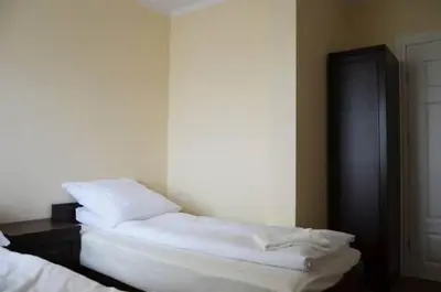 a room with two white pillows on a bed at Pokoje Gościnne w Ratuszu in Ogrodzieniec