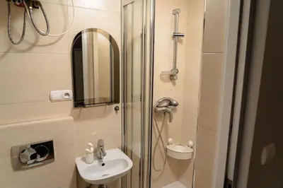 a bathroom with a shower and a sink at Asnyka Old Town in Kraków