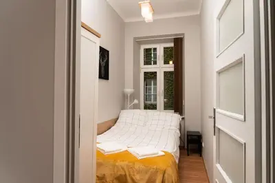 a small bedroom with a bed and a window at Asnyka Old Town in Kraków