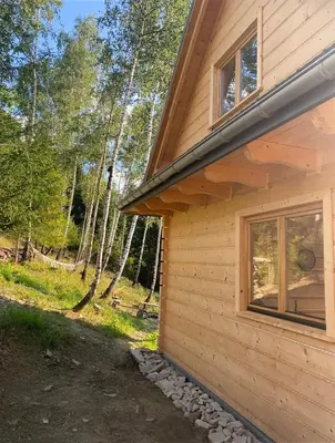 a house with a window on the side of it at Babiogórskie klimaty in Zawoja