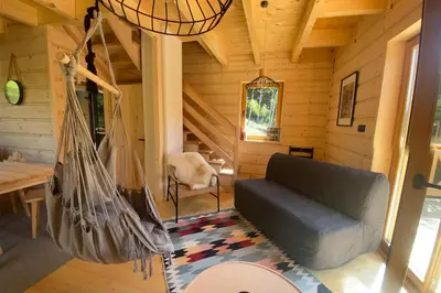 a living room with a couch and a hammock at Babiogórskie klimaty in Zawoja