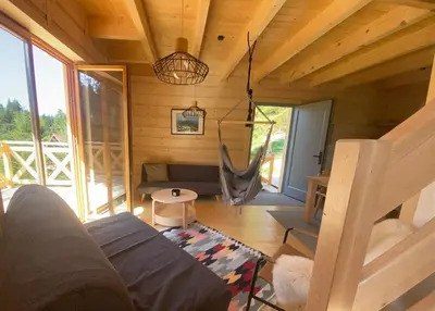 a living room with a couch in a cabin at Babiogórskie klimaty in Zawoja