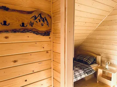 a log cabin with a small bed in the corner at Babiogórskie klimaty in Zawoja