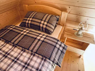a small room with two beds and a fan at Babiogórskie klimaty in Zawoja