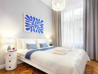 a white bedroom with a large bed with a blue painting at GREEN CHILL Apt Old Town & Wawel Hill by Vistula River - by Homelike Krakow in Kraków