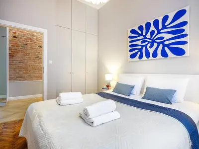 two beds in a white room with towels on them at GREEN CHILL Apt Old Town & Wawel Hill by Vistula River - by Homelike Krakow in Kraków