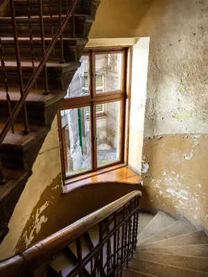 a staircase with a window in an old building at GREEN CHILL Apt Old Town & Wawel Hill by Vistula River - by Homelike Krakow in Kraków
