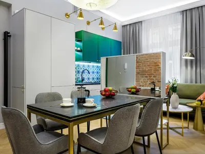 a kitchen and dining room with a table and chairs at GREEN CHILL Apt Old Town & Wawel Hill by Vistula River - by Homelike Krakow in Kraków