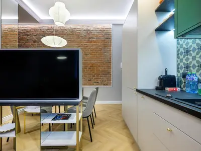 a kitchen with a large flat screen tv on a counter at GREEN CHILL Apt Old Town & Wawel Hill by Vistula River - by Homelike Krakow in Kraków