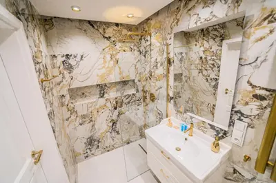 a bathroom with a sink and a mirror at Kazimierza Wielkiego Luxury Apartment by BookingHost in Kraków