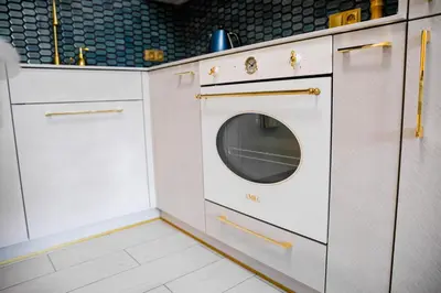 a kitchen with a washer and dryer in a room at Kazimierza Wielkiego Luxury Apartment by BookingHost in Kraków