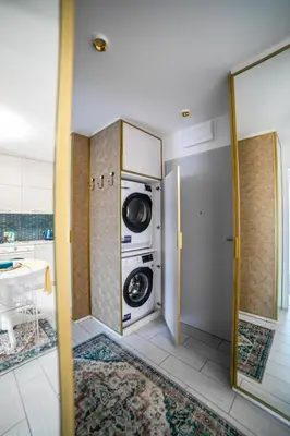 a laundry room with a washer and dryer at Kazimierza Wielkiego Luxury Apartment by BookingHost in Kraków