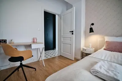 a bedroom with a bed and a desk and a chair at Pankrac 2 by Housine in Zator
