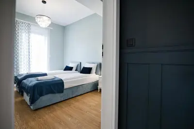 a bedroom with a bed with blue walls at Pankrac 2 by Housine in Zator