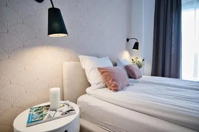 a bedroom with a bed and a table with a side table at Pankrac 2 by Housine in Zator