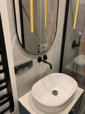 a bathroom with a white sink and a mirror at Indygo Apartment in Kraków