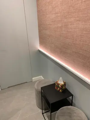 a room with a table and a stool and a window at Indygo Apartment in Kraków