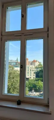 a window with three views of a city at JUWEL Apartments Kraków z widokiem na Wawel ap 31 in Kraków