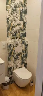 a bathroom with a white toilet and a wall at JUWEL Apartments Kraków z widokiem na Wawel ap 31 in Kraków