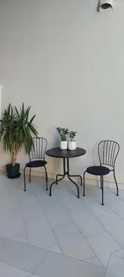 a table and two chairs and a table with plants at JUWEL Apartments Kraków z widokiem na Wawel ap 31 in Kraków