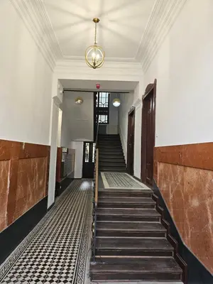 an empty hallway with stairs in a building at JUWEL Apartments Kraków z widokiem na Wawel ap 31 in Kraków