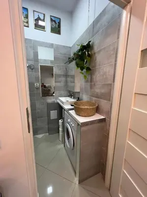 a bathroom with a washing machine and a sink at Salt INN Apartments No 1 in Wieliczka